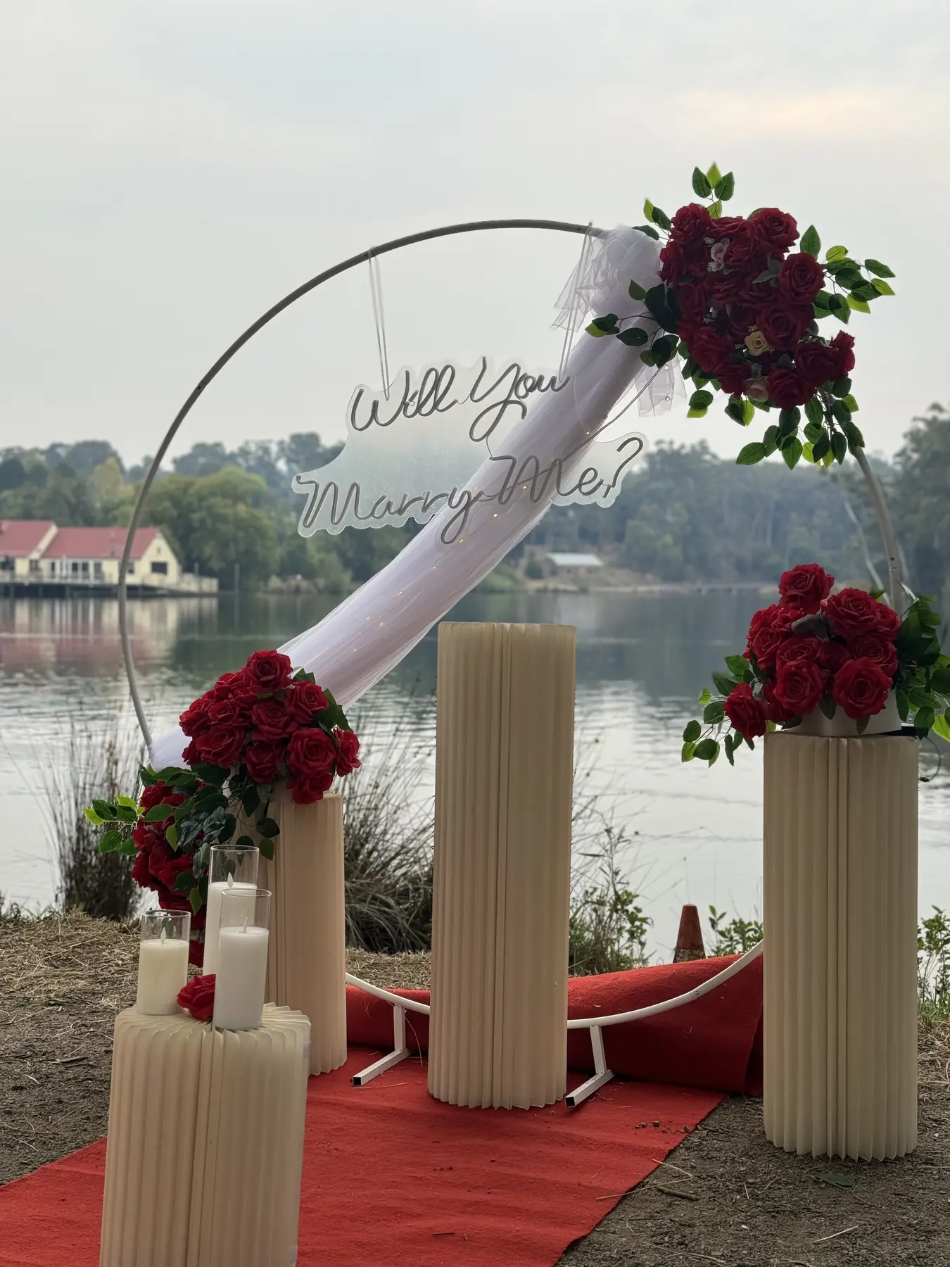 Rose arch with roman pillars and candles beside a lake in a Melbourne park